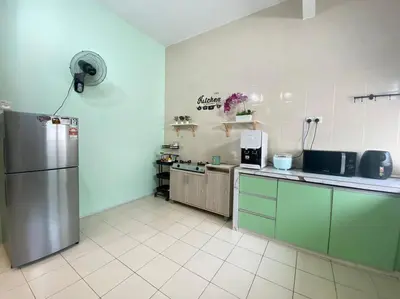 a kitchen with a stainless steel refrigerator in a room at Deandra Homestay- WiFi-Aircond-Dryer in Sungai Petani