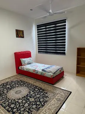 a bedroom with a red bed and a window at Deandra Homestay- WiFi-Aircond-Dryer in Sungai Petani