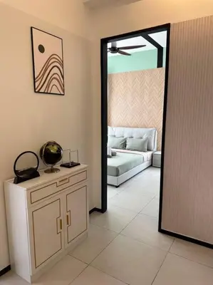 a living room with a door leading to a couch at High Floor, 3BR 3queen bed, 2 parking, Urban Suites by XWHome in Jelutong