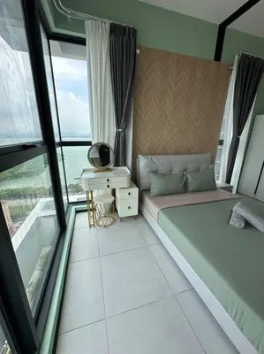 a bedroom with a bed and a desk and windows at High Floor, 3BR 3queen bed, 2 parking, Urban Suites by XWHome in Jelutong