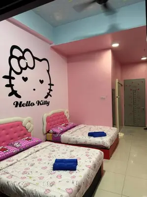a room with two beds with hello kitty on the wall at Hello Kitty HomeStay - Cameron Highlands - Spacious Studio - Perfect for Families - Sleeps 4 and Baby in Tanah Rata