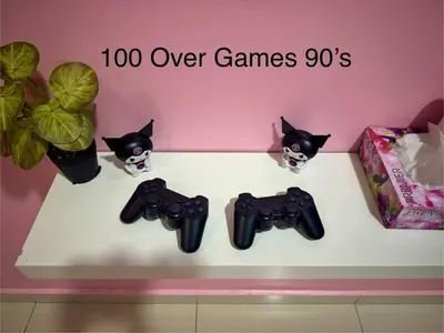 a shelf with two black cat figurines and consoles at Hello Kitty HomeStay - Cameron Highlands - Spacious Studio - Perfect for Families - Sleeps 4 and Baby in Tanah Rata