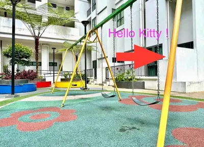 an empty playground in front of a building with a red arrow at Hello Kitty HomeStay - Cameron Highlands - Spacious Studio - Perfect for Families - Sleeps 4 and Baby in Tanah Rata