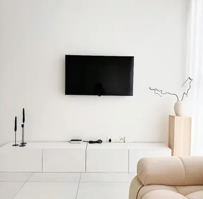 a living room with a tv on a white wall at Georgetown Seaview & Cityview Skypool with 2 Carpark in Jelutong