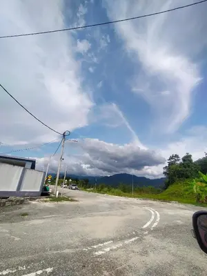 a view of a road with a cloudy sky at Angah Homestay in Kampong Chabang