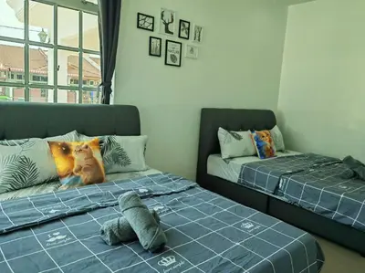 a bedroom with two beds and a stuffed animal on the bed at Cozy Deluxe House Padang Serai 28pax in Padang Serai