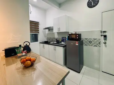 a kitchen with a bowl of fruit on a table at Ipoh Midtown Anderson Suite 2R2B in Ipoh
