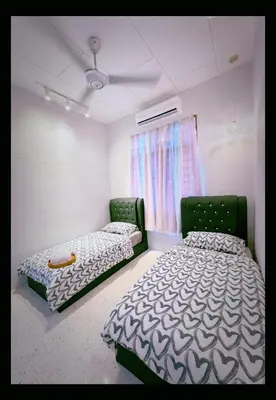 a bedroom with two beds and a ceiling fan at Mk&V butterworth in Butterworth