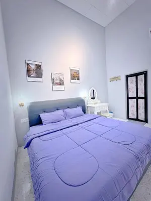 a white bedroom with a large bed with purple sheets at Mk&V butterworth in Butterworth