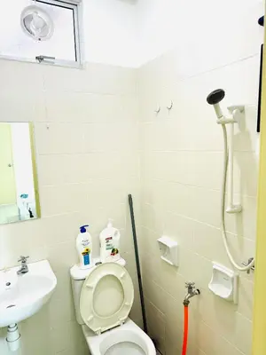 a bathroom with a toilet and a sink at Spc Arena Apartment Service in Bayan Lepas