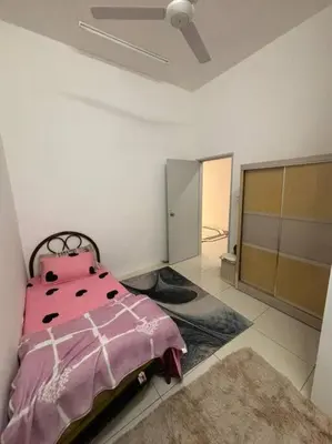 a bedroom with a pink bed in a room at Hz homestay in Simpang Ampat