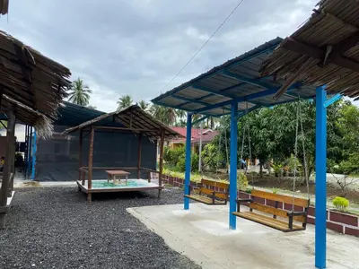 a park with benches and a pavilion at Dalya's Roomstay in Tanjung Karang