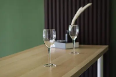two wine glasses sitting on top of a wooden table at Anderson Mountain View by Xuites-6 Pax-Free Netflix-6 mins to Concubine Lane in Ipoh