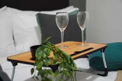 a table with two wine glasses and a plant on it at Anderson Mountain View by Xuites-6 Pax-Free Netflix-6 mins to Concubine Lane in Ipoh
