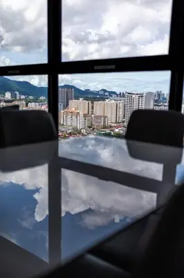 a window with two chairs and a view of a city at #U27 #3BR Family Staycation in Jelutong