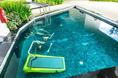 a pool with a swing in the water at #U27 #3BR Family Staycation in Jelutong