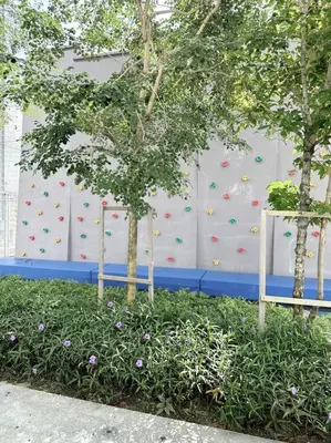 two trees in front of a climbing wall at Urban Emerald Seaview 6Pax 3Queen 3Room 2Bath 2Carpark with Infinity Pool in Jelutong