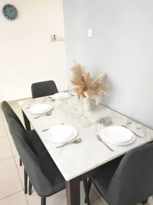 a dining room table with chairs and a table with plates at 2bedroom 2bath 13th Seaview MansionOne Gurney in George Town