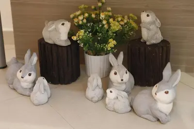 a group of rabbits and a vase with flowers at Big Orange Hotel Sungai Petani in Sungai Petani