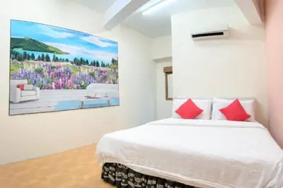 a bedroom with a bed with a painting on the wall at B Hotel Penang in George Town
