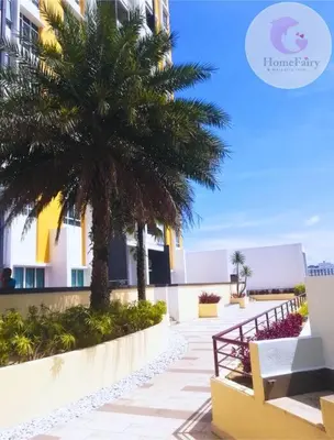 a palm tree and a bench in front of a building at The Majestic Condo Ipoh Home Fairy 2 in Ipoh