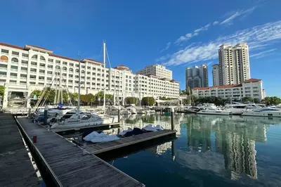a marina with boats in the water and buildings at Straits Quay Highest Floor PoolView Suite in Tanjong Tokong