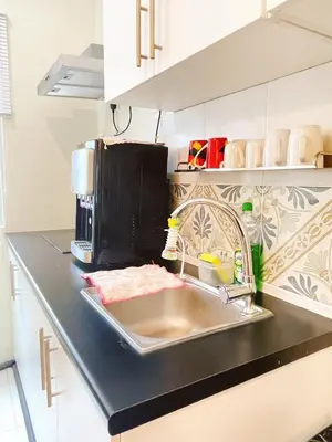 a kitchen counter with a sink and a microwave at The Floral Dawn Anderson in Kampong Simee