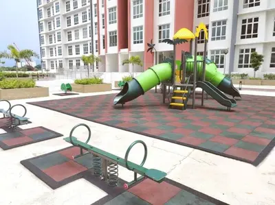 a playground with a slide and benches in front of a building at The Floral Dawn Anderson in Kampong Simee