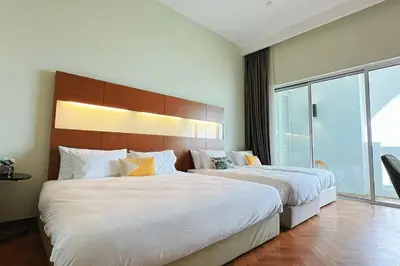 a hotel room with two beds and a large window at Straits Quay Highest Floor Infinity SeaView Suite in Tanjong Tokong