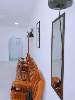 a row of wooden benches and mirrors on a wall at Gioia DeGarden in Taiping