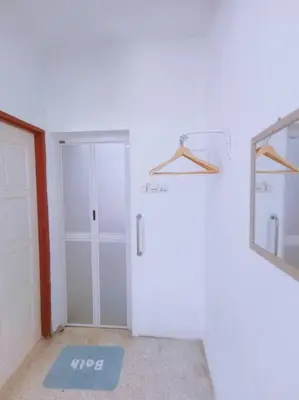 an empty room with a door and a mirror at Gioia DeGarden in Taiping