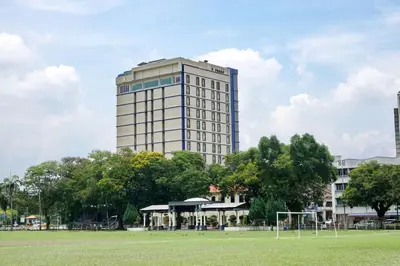 a tall building with a soccer field in front of it at Cititel Express Ipoh in Ipoh
