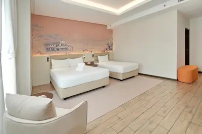 a hotel room with two beds and a couch at Cititel Express Ipoh in Ipoh