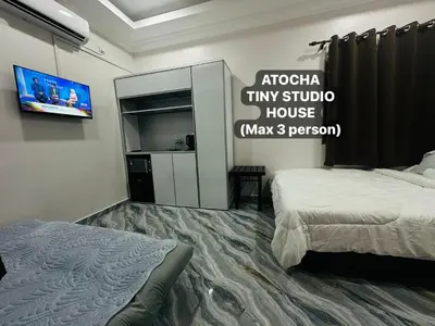 a hotel room with a bed and a tv at Atocha Tiny Studio House - Temerlok Terong, Perak - max 3 person only in Kampong Salak