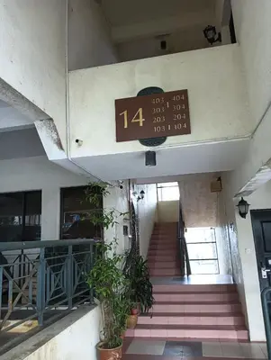 a clock on the side of a building with stairs at Cozy Nest 1 Bedroom Apartment at Equatorial Hill Resort in Brinchang