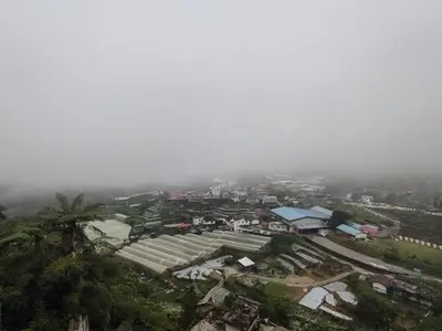 an overhead view of a city in the fog at Cozy Nest 1 Bedroom Apartment at Equatorial Hill Resort in Brinchang