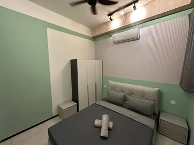 a small bedroom with a bed with a brown object on it at PICO VR, 3BR 3 queen bed, 2 car park, UrbanSuites by XW Home in Jelutong