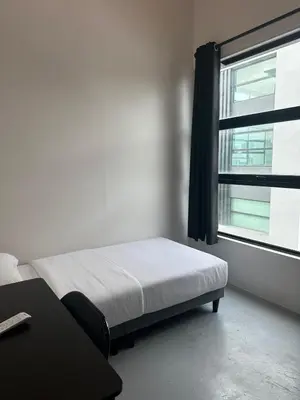 a bedroom with a bed and a window at Be Right Back Loft - Alma in Kampong Ayer Merah
