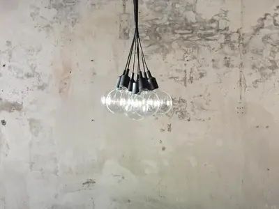 a cluster of lights hanging from a wall at The Frame Guesthouse in George Town