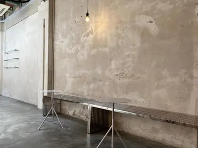 two tables against a wall in a room at The Frame Guesthouse in George Town