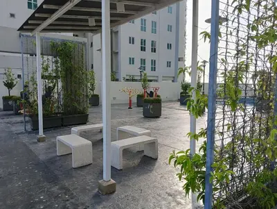 a group of benches in a courtyard with a building at 28th 2BR1B Straits Garden Suites Georgetown Penang in Jelutong
