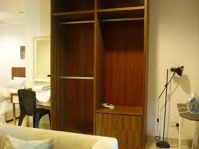 a bedroom with a wooden closet with a bed at Studio at Middle floor sea view in George Town