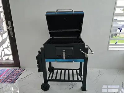 a bbq grill sitting on top of a cart at The Bangau Cottage in Sungai Petani