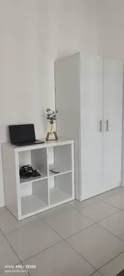 a white cabinet with a laptop on top of it at Ipoh Anderson Free WiFi & Tvbox 4ppl in Ipoh