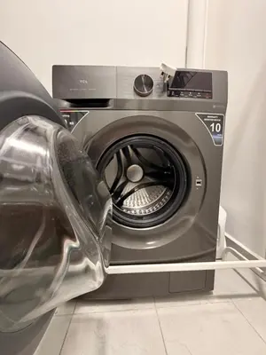 a washing machine with its door open in a room at NeoSkyhigh Suites in Batu Kawan