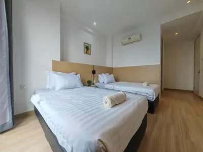 two beds in a hotel room with white sheets at Luxe Romance with Seaview & Bathtub - Jazz Suites by Ocean Luxe in Tanjong Tokong