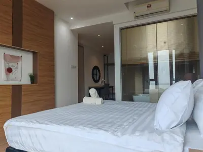 a bedroom with a large bed with white sheets and pillows at Luxe Romance with Seaview & Bathtub - Jazz Suites by Ocean Luxe in Tanjong Tokong