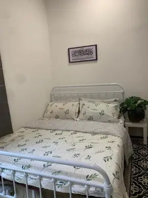 a bed in a bedroom with a bed frame and pillows at Ereens homestay 3 bedroom apartment in Brinchang
