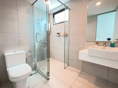 a bathroom with a shower and a toilet and a sink at Sea Breeze Haven 2BR Seaview w Bathtub 海风乐园海景套房 by Minsù in Tanjong Tokong