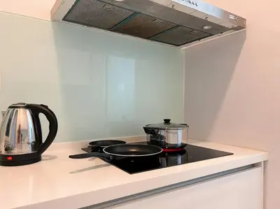 a stove top with two pots and a tea kettle at Sea Breeze Haven 2BR Seaview w Bathtub 海风乐园海景套房 by Minsù in Tanjong Tokong